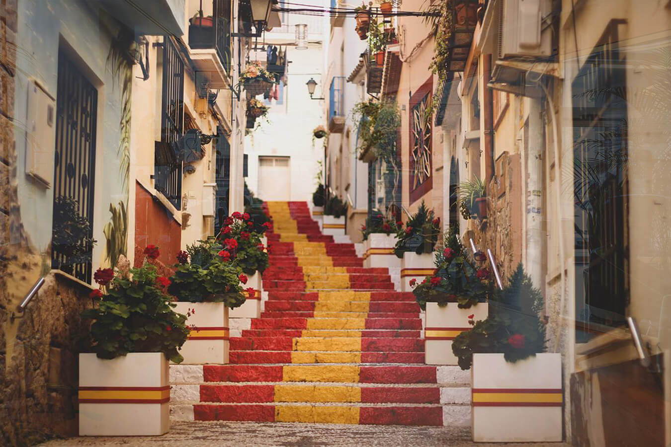 stairs in a city coloured with spanish flag colours